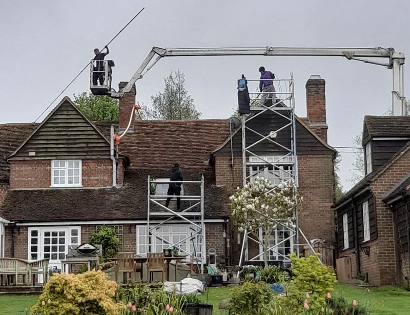The Moss Cleaners using cherry picker and scaffolding to clean roof safely and professionally in Stubbington, Hampshire